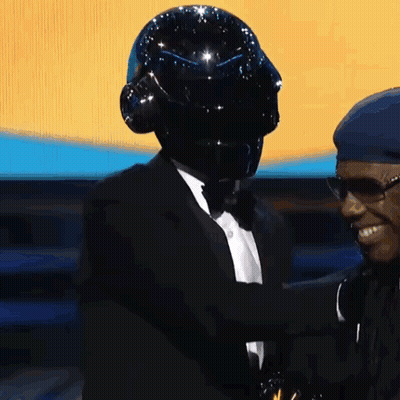 Two Men One In Black Helmet And Tuxedo GIF