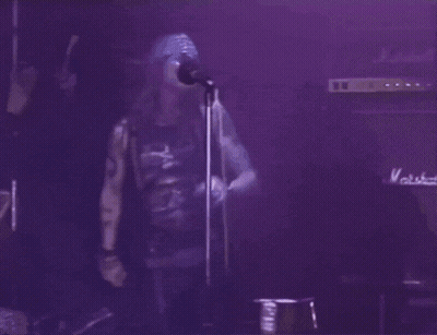 Two Men, One In Guns N' Roses Shirt GIF