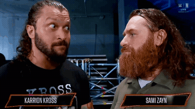 Two Men One Wearing Karrion Kross Shirt GIF