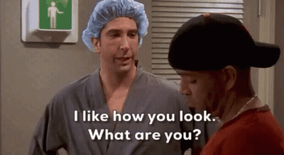 Two Men, One Wearing Surgical Cap And Robe GIF