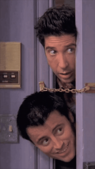 Two Men Peeking Out Of A Purple Door With A Chain Around Them GIF