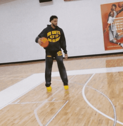 Two Men Playing Basketball In Front Of A Poster That Says " Lakers " On It GIF
