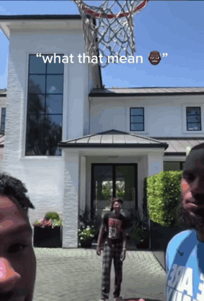 Two Men Playing Basketball In Front Of A White House With The Words " What That Mean " On The Bottom GIF