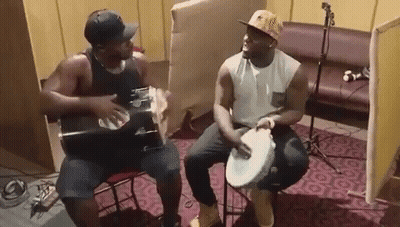 Two Men Playing Drums And Guitar GIF