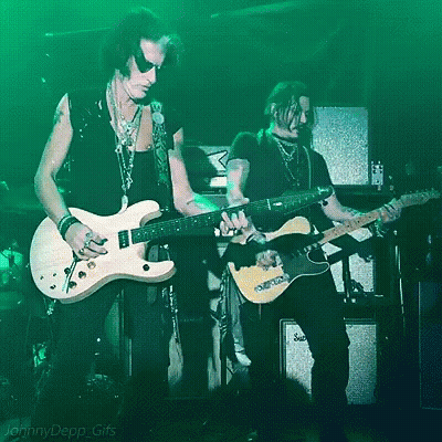 Two Men Playing Guitars In Front Of A Green Background That Says Jenny Depp Gifs On It GIF