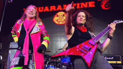 Two Men Playing Guitars In Front Of Quarantine Sign GIF