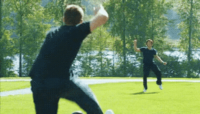 Two Men Playing Soccer One Kicking Ball GIF