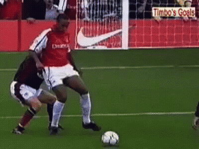 Two Men Playing Soccer With Timbo's Goals Sign GIF