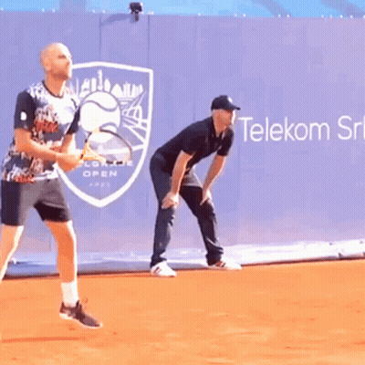 Two Men Playing Tennis In Front Of Telekom Ad GIF