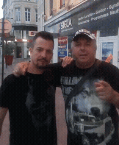 Two Men Posing For A Picture In Front Of A Sigla Store GIF