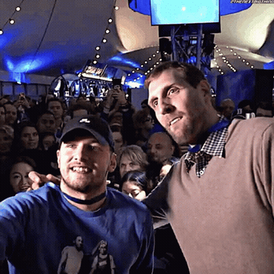 Two Men Posing In Crowd, One With Nike Hat GIF