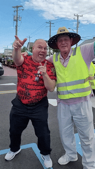 Two Men Posing One Wearing Reese Shirt GIF
