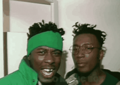 Two Men Posing One With Green Headband GIF