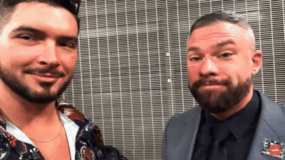 Two Men Posing, One With Tommy Hilfiger Pin GIF
