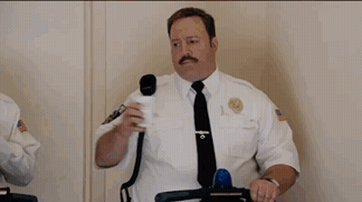 Two Men Riding Segways In Front Of An Exit Sign GIF