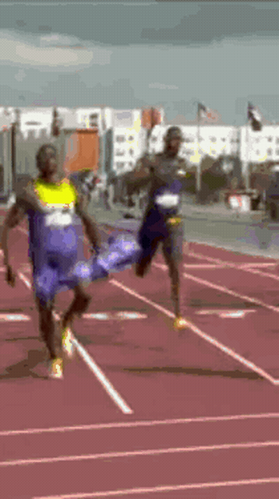 Two Men Running On Track One In Blue Shirt Saying A GIF