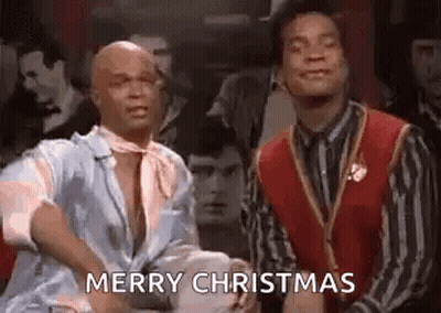 Two Men Saying Merry Christmas In A Bar GIF
