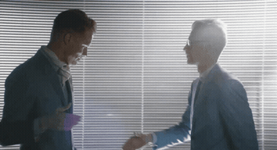 Two Men Shaking Hands In Front Of A Window GIF