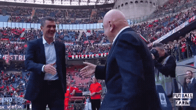 Two Men Shaking Hands In Front Of Brigate Sign GIF