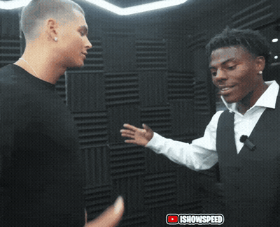 Two Men Shaking Hands in Front of iShowspeed Wall