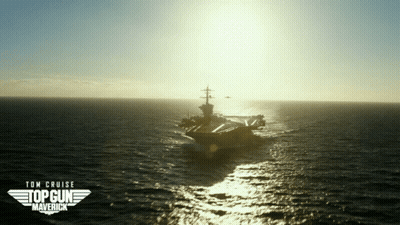 Two Men Shaking Hands In Front Of Planes GIF