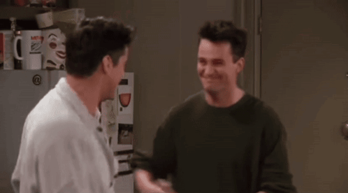 Two Men Shaking Hands In Front Of Refrigerator GIF