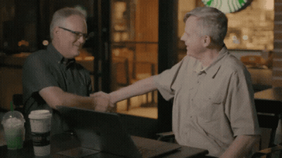 Two Men Shaking Hands In Front Of Starbucks Logo GIF