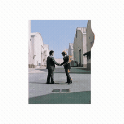 Two Men Shaking Hands Next To Statue GIF