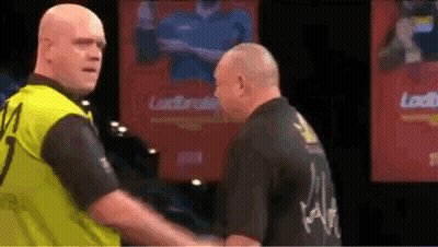 Two Men Shaking Hands On Stage With Loud Sign GIF