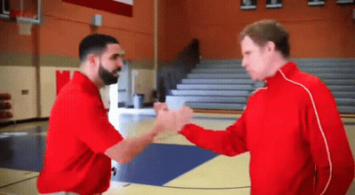 Two Men Shaking Hands One In Red Shirt GIF