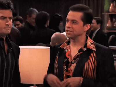 Two Men Side By Side In Crowded Room GIF