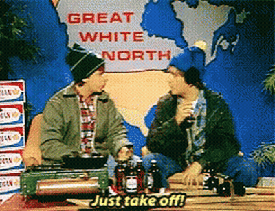 Two Men Sit At A Table With A Sign That Says Great White North GIF