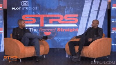 Two Men Sit In Chairs In Front Of A Screen That Says Strs GIF
