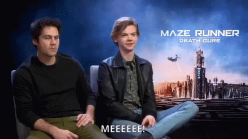Two Men Sit In Front Of A Maze Runner Death Cure Poster GIF