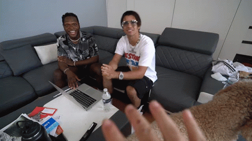 Two Men Sit On A Couch With One Wearing A T-Shirt That Says Estr On It GIF