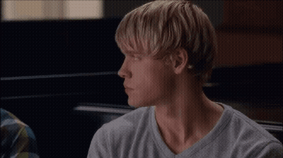 Two Men Sitting And Looking At Each Other GIF