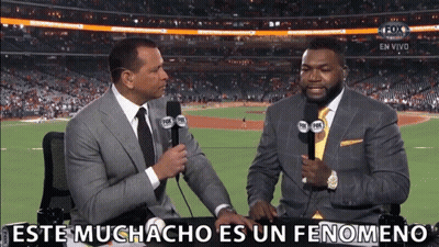Two Men Sitting At A Table With Microphones And The Words Este Muchacho Es Un Fenomeno Written On The Bottom GIF