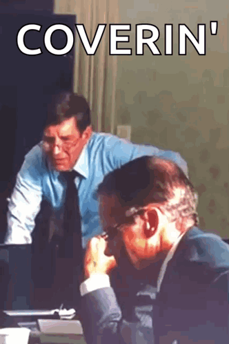 Two Men Sitting At A Table With The Words Coverin ' Written On The Bottom GIF