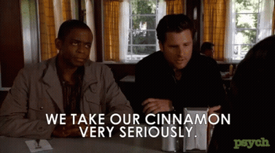 Two Men Sitting At A Table With The Words We Take Our Cinnamon Very Seriously GIF
