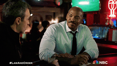 Two Men Sitting At Bar With NBC Logo GIF