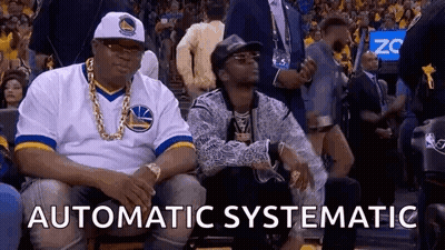 Two Men Sitting At Basketball Game One In Warriors Jersey GIF