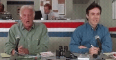 Two Men Sitting At Desk With Microphones GIF