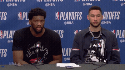 Two Men Sitting At Playoffs Table GIF