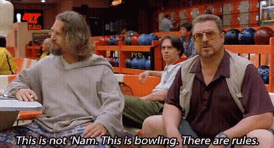 Two Men Sitting At Table In Bowling Alley GIF