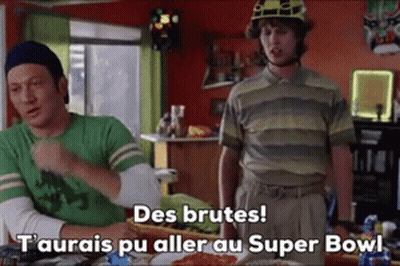 Two Men Sitting At Table One Wearing Helmet GIF
