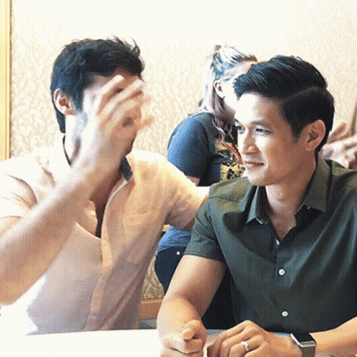 Two Men Sitting At Table, One Wearing Watch GIF