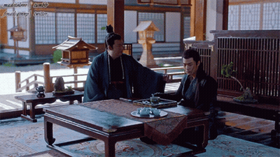Two Men Sitting At Table GIF