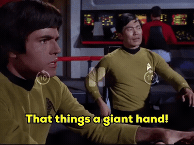 Two Men Sitting At Table Saying That Things A Giant Hand GIF
