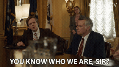 Two Men Sitting At Table Saying You Know Who We Are GIF
