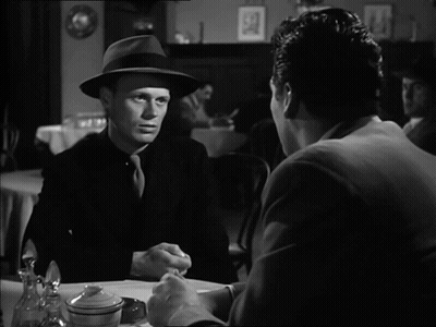 Two Men Sitting At Table Talking GIF